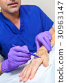Plastic Surgeon Doctor Marks Hand of Senior Woman 30963147