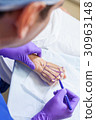 Plastic Surgeon Doctor Marks Hand of Senior Woman 30963148
