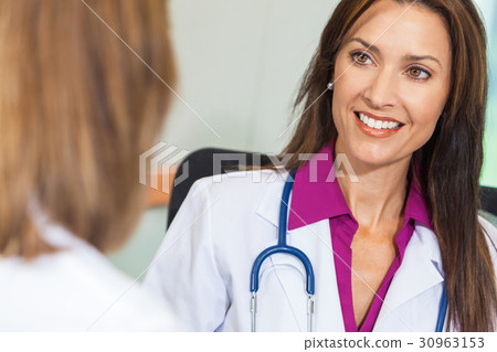 Woman Doctor in Hospital Meeting with Colleague Woman Doctor in Hospital Meeting with Colleague 30963153