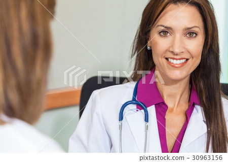 Woman Doctor in Hospital Meeting with Colleague Woman Doctor in Hospital Meeting with Colleague 30963156