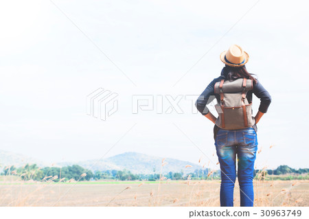 Happy woman traveler looking to blue sky  30963749