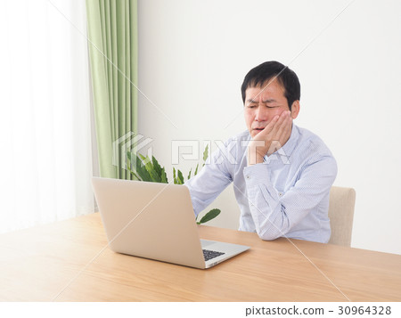 A man who thinks by looking at the screen of a personal computer 30964328