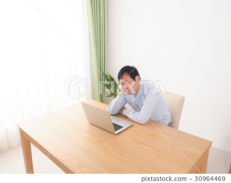 A man falling down looking at the screen of a personal computer 30964469