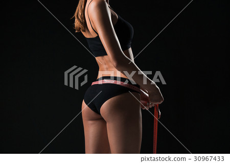 The fit woman measuring perfect shape of beautiful The fit woman measuring perfect shape of beautiful 30967433