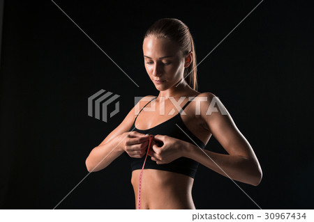 The fit woman measuring perfect shape of beautiful The fit woman measuring perfect shape of beautiful 30967434