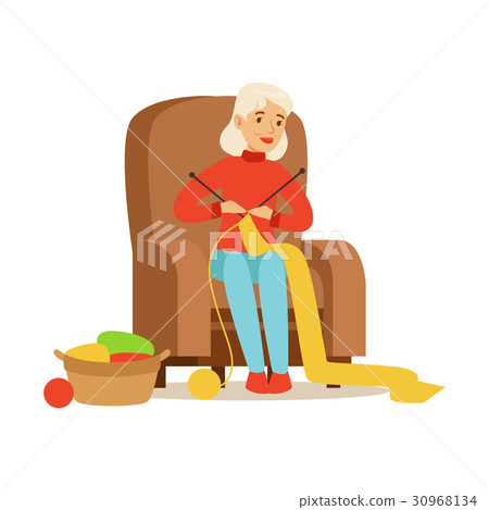 Grandmother knitting scarf sitting in a chair 30968134