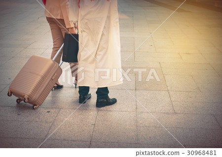 Arab man and woman walking carrying a suitcase Arab man and woman walking carrying a suitcase 30968481