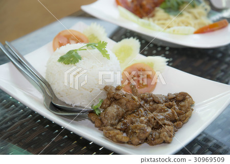 Rice with pork fried with garlic on white plate Rice with pork fried with garlic on white plate 30969509