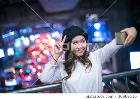 Happy asian woman taking selfie joyful and happy smiling Happy asian woman taking selfie joyful and happy smiling 30969510