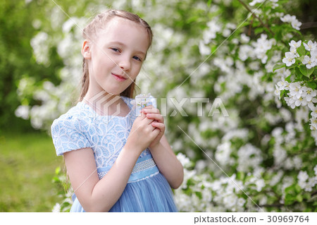 Little girl in blooming apple tree spring garden 30969764