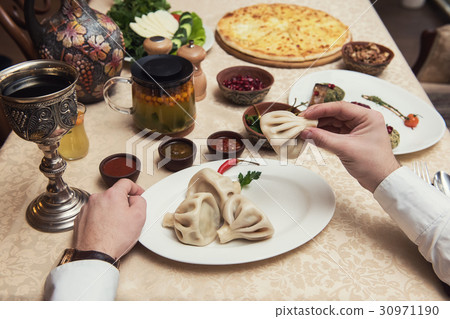 Man eating in georgian restaurant 30971190