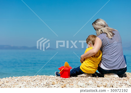 A happy mother and young child boy son having fun 30972192