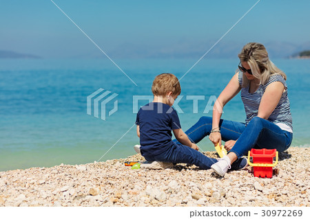 A happy mother and young child boy son having fun A happy mother and young child boy son having fun 30972269