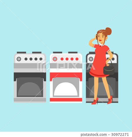 Young woman choosing an electric stove in home Young woman choosing an electric stove in home 30972271