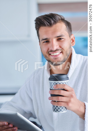 Morning portrait of handsome young man with cup of Morning portrait of handsome young man with cup of 30972476
