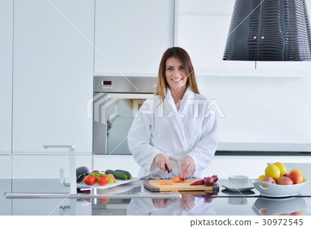 Smiling beautiful woman preparing salad at morning Smiling beautiful woman preparing salad at morning 30972545