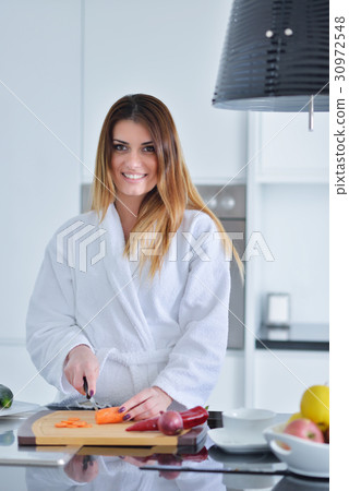Smiling beautiful woman preparing salad at morning 30972548