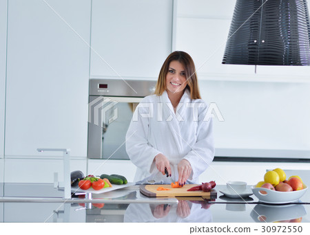 Smiling beautiful woman preparing salad at morning Smiling beautiful woman preparing salad at morning 30972550