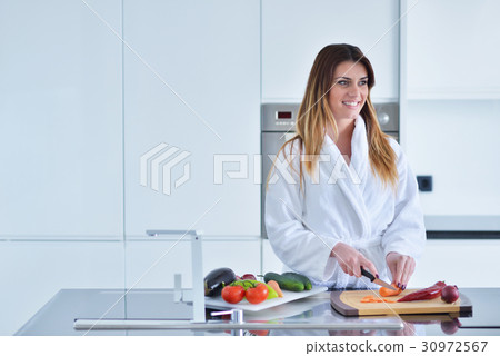 Smiling beautiful woman preparing salad at morning Smiling beautiful woman preparing salad at morning 30972567
