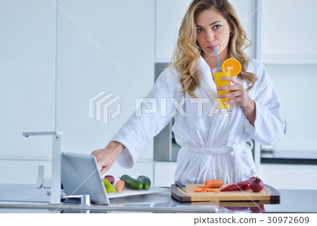 Smiling beautiful woman preparing salad at morning Smiling beautiful woman preparing salad at morning 30972609