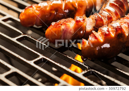Grilling sausages on barbecue grill Grilling sausages on barbecue grill 30972792