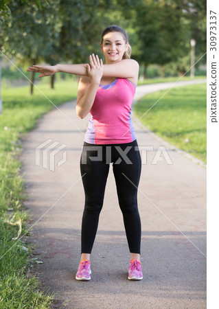 Woman is stretching before jogging. Fitness and Woman is stretching before jogging. Fitness and 30973137