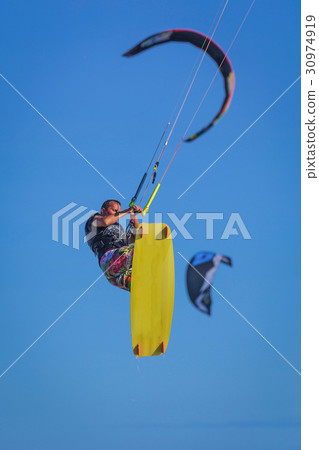 Young atletic man riding kite surf on a sea 30974919