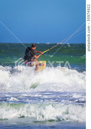 Young atletic man riding kite surf on a sea 30974922
