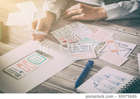 Designer drawing website ux app development. 30975680