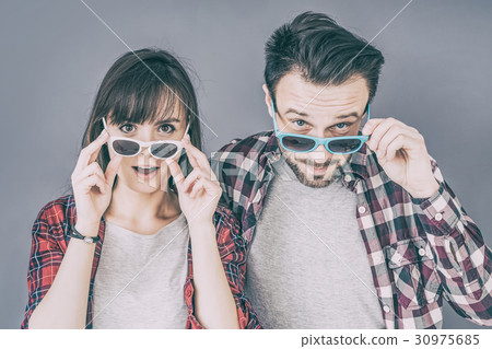 A pair of young people leave glasses and mouth 30975685