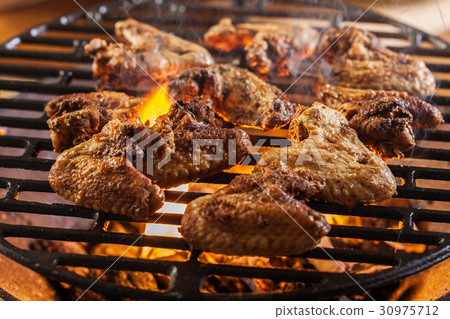 Grilling chicken wings on barbecue grill Grilling chicken wings on barbecue grill 30975712
