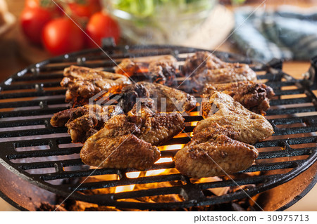 Grilling chicken wings on barbecue grill Grilling chicken wings on barbecue grill 30975713