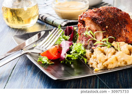 Pork knuckle with fried sauerkraut 30975733