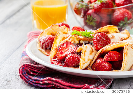 Traditional crepes served with strawberries 30975756