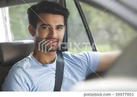 Portrait of young man sitting in car 30977001