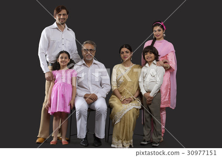 Portrait of smiling Indian multi-generation family in retro 70s clothing 30977151