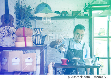 Senior adult man barista making coffee in cafe 30980979