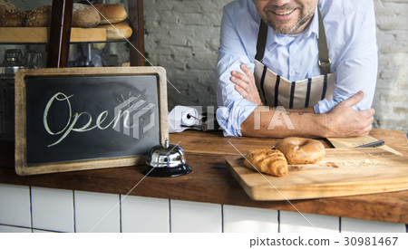 African Man with Open Sign in Bakery Shop African Man with Open Sign in Bakery Shop 30981467