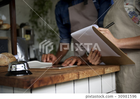 Men Checking Stock of Pastry in Bakery Shop Men Checking Stock of Pastry in Bakery Shop 30981596