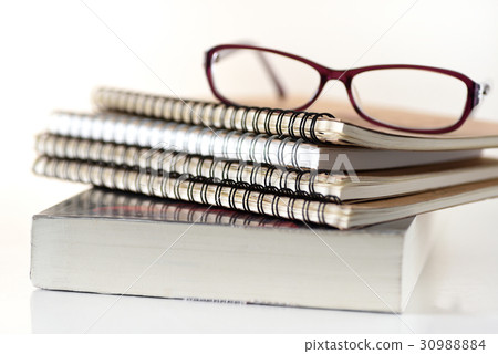 Books and glasses on white background 30988884