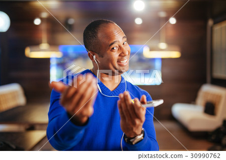 attractive man in headphones listening music 30990762