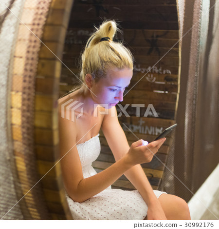Young cheerful woman using smarthphone. 30992176