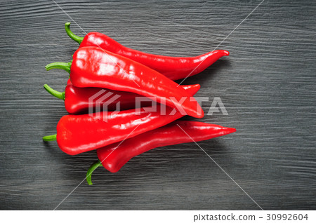 Sweet red Kapia peppers on a dark shale stone 30992604