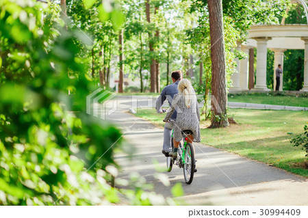 couple with tandem bicycle 30994409