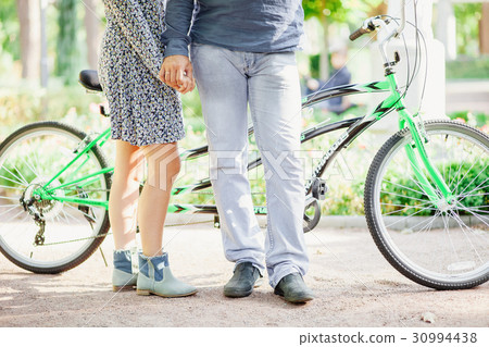 couple with tandem bicycle 30994438