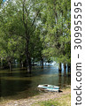 Old wooden fishing boat near the summer lake shore 30995595