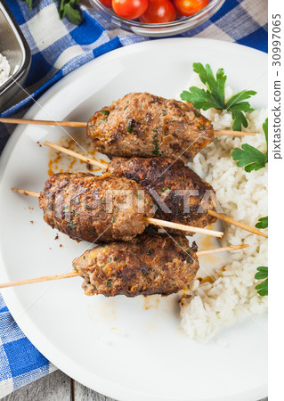 Barbecued kofta with rice on a plate 30997065