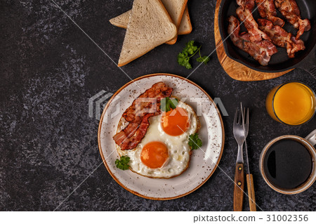 Breakfast with bacon , fried egg, coffee Breakfast with bacon , fried egg, coffee 31002356