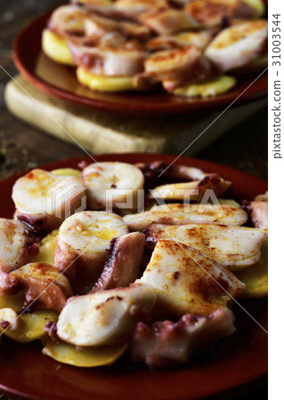 pulpo a la gallega, a spanish recipe of octopus 31003544
