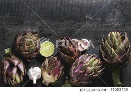 Uncooked purple artichokes Uncooked purple artichokes 31003706